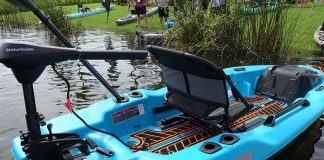 Blue Pelican Catch PWR 100 fishing kayak with trolling motor at riverside