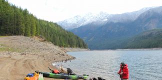 kayak anglers prepare on the shore of Ross Lake in Washington