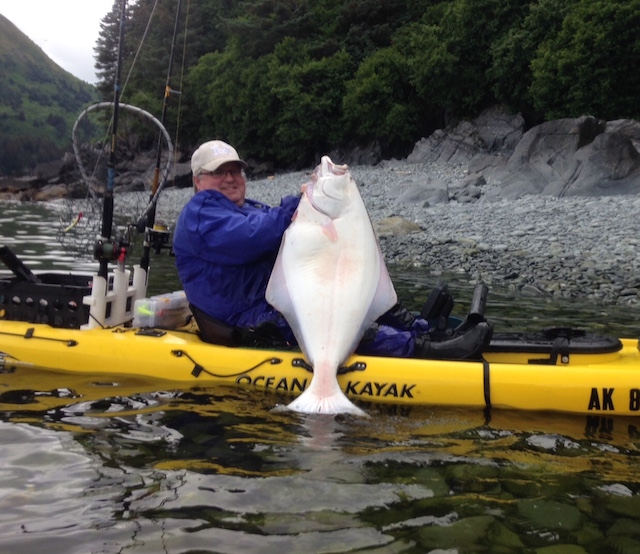 Ryan Black holds up a giant Alaskan halibut caught in 60ft of water. Photo: Lance Peterson