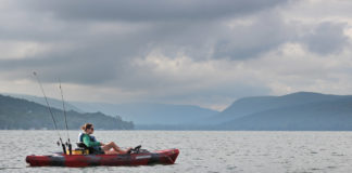 woman kayak fishing in the Finger Lakes region of New York state
