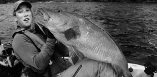 Angler Morgan Promnitz holding a large fish in a kayak