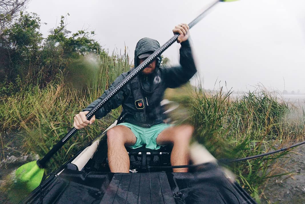 man paddles a fishing kayak with a perfect size paddle