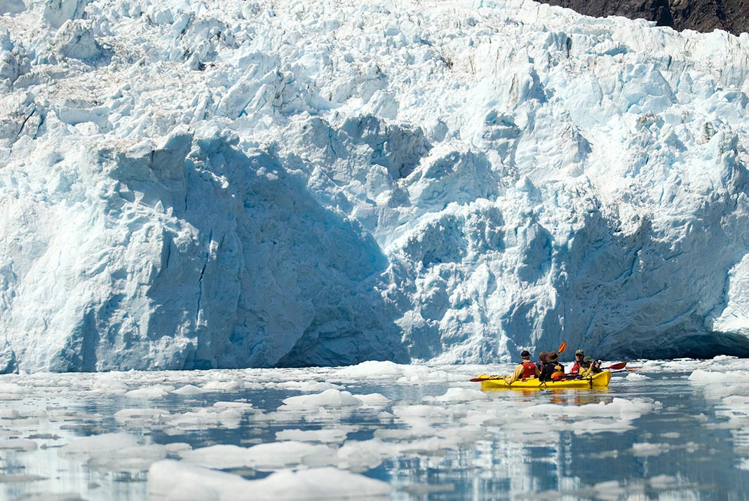 Kayakers in front of a glacier at Kenai Fjords National Park