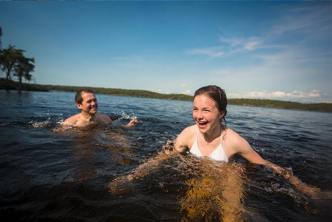 Two people swimming and laughing