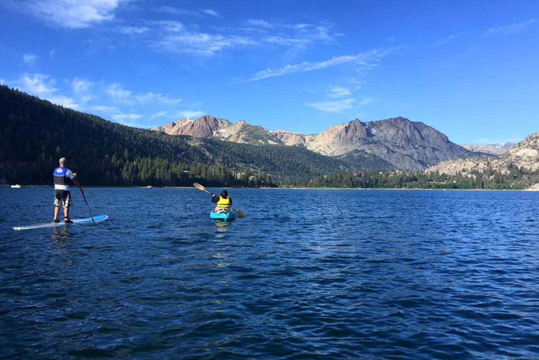 Kayaking on the water with mountains in the background