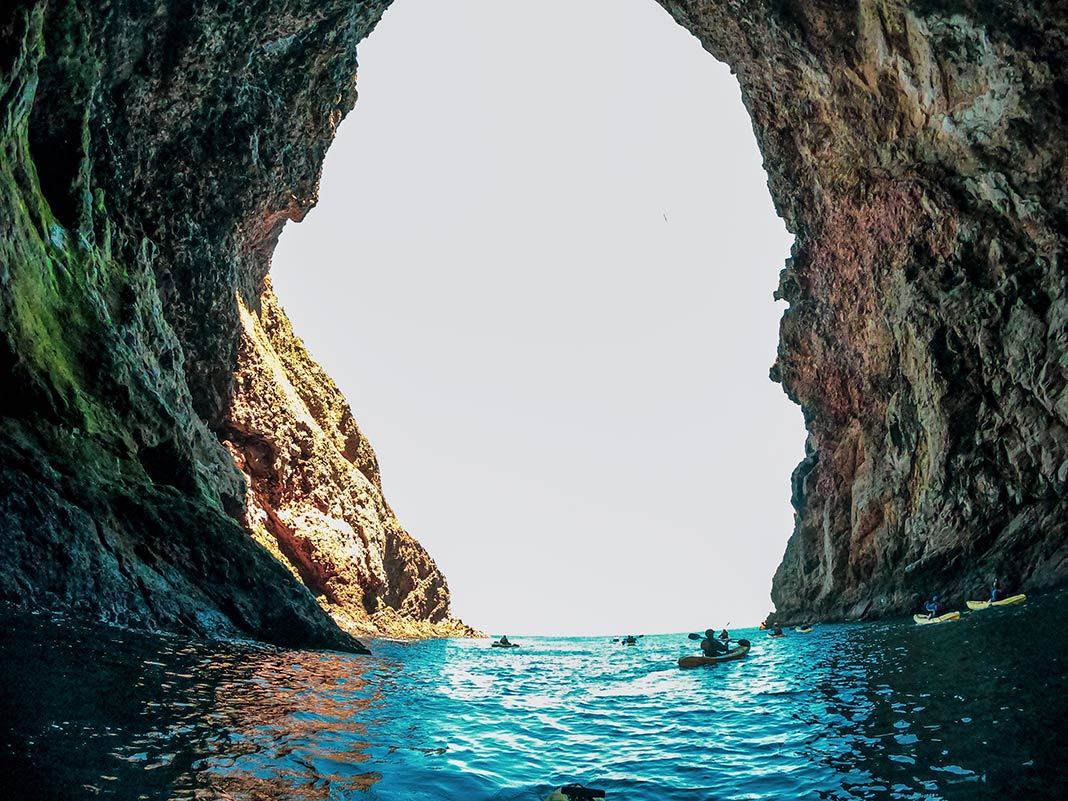Kayakers paddling in a painted cave in the Channel Islands