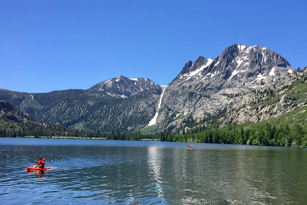 Kayakers on Silver Lake with mountains in the background