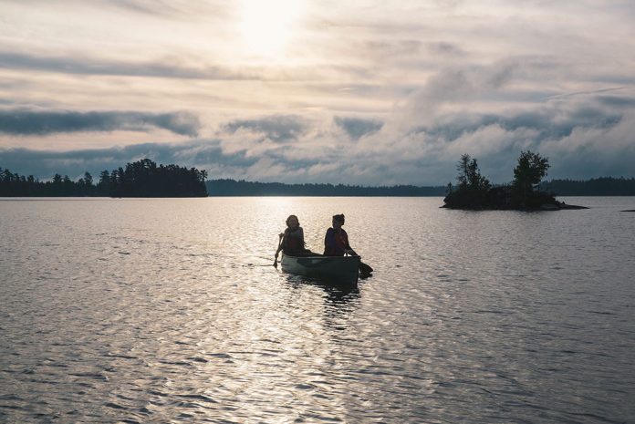 Canoeists on the water on a cloudy day