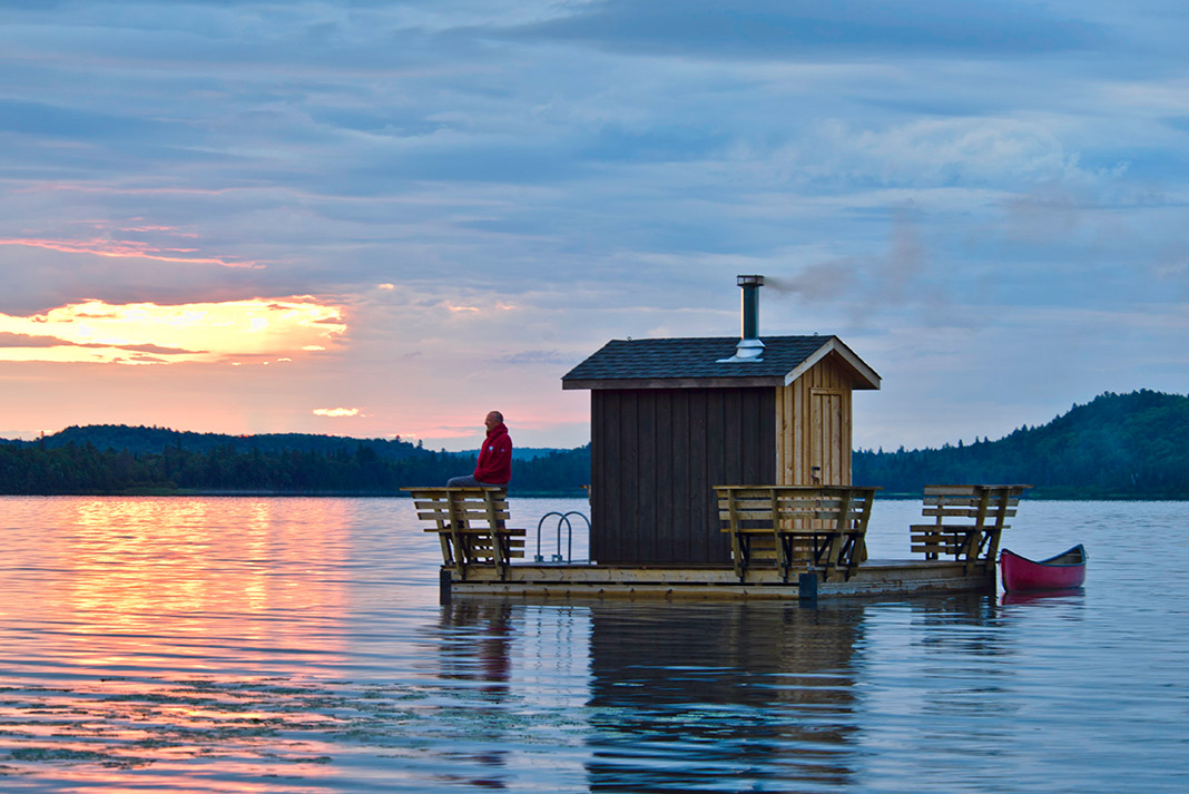 People on a floating sauna boat on the water