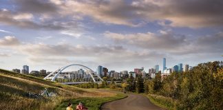 A view of Edmonton from afar with people relaxing in the forefront