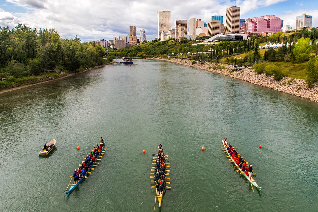 People paddling in voyageur canoes outside of Edmonton