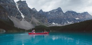 A red canoe on turquoise waters of Moraine Lake