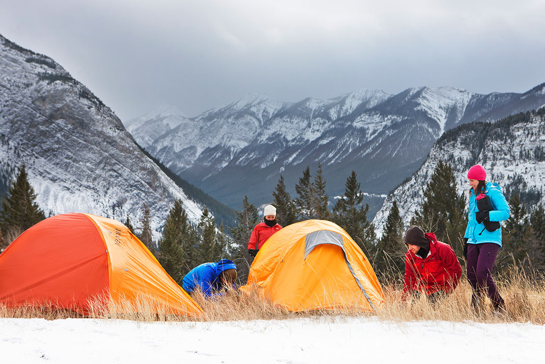 Campers setting up tents on the snowcapped mountains in Banff