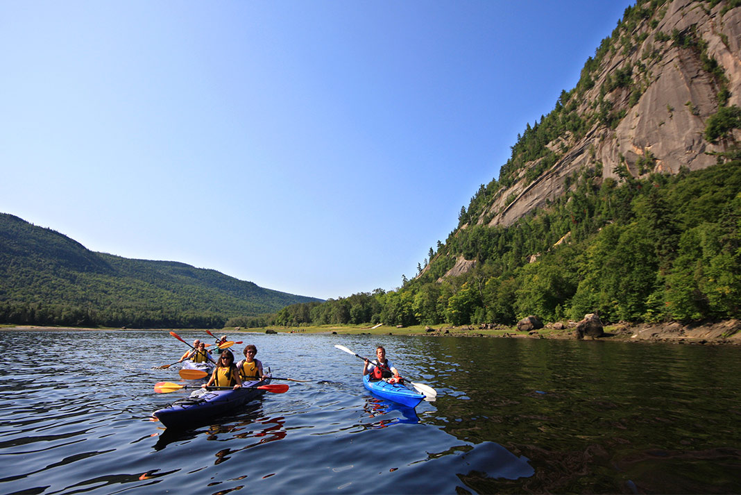 A group of kayakers paddle in Saguenay