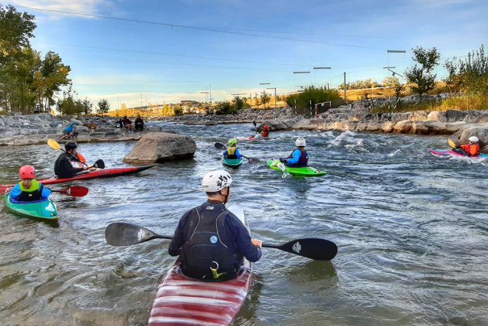 Many whitewater kayakers on Harvie Passage