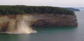 Collapsing cliff into water below