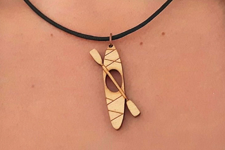 Necklace with canoe and paddle.