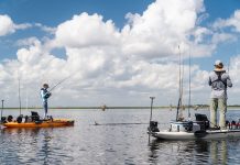 two anglers standup fishing from their anchored fishing kayaks
