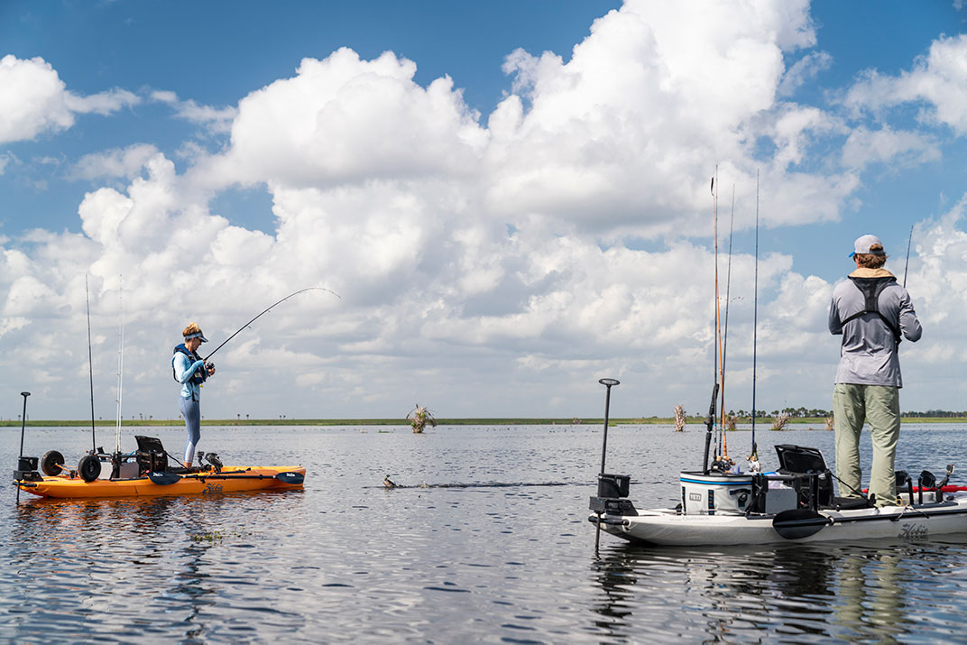 two anglers standup fishing from their anchored fishing kayaks