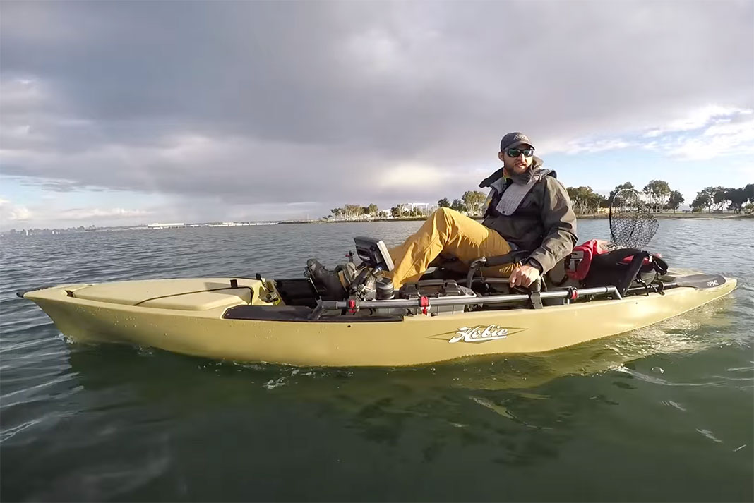 man pedals a Hobie Pro Angler 14 fishing kayak