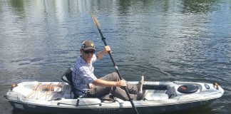 man paddles the Pelican Catch 100 fishing kayak