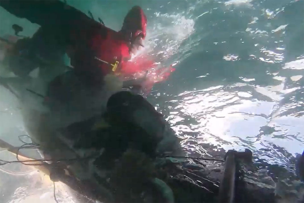 chaotic underwater view of a capsized fishing kayak