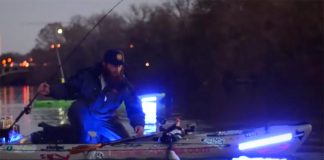 two men kayak fishing at dusk with supernova fishing lights