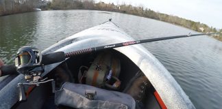 Ugly Stik GX2 casting rod sits across the bow of a fishing boat