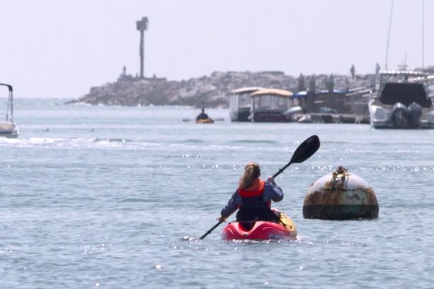 Kate Kuthe navigates a busy channel in a kayak.