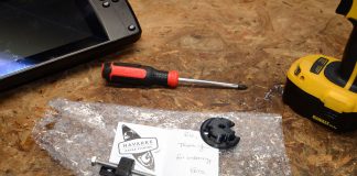 transducer adapter from a grassroots kayak fishing gear supplier sits on a workbench