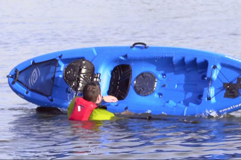 ACA instructor Paul Kuthe demonstrates how to get back into a kayak after flipping. | Photo courtesy of ACA
