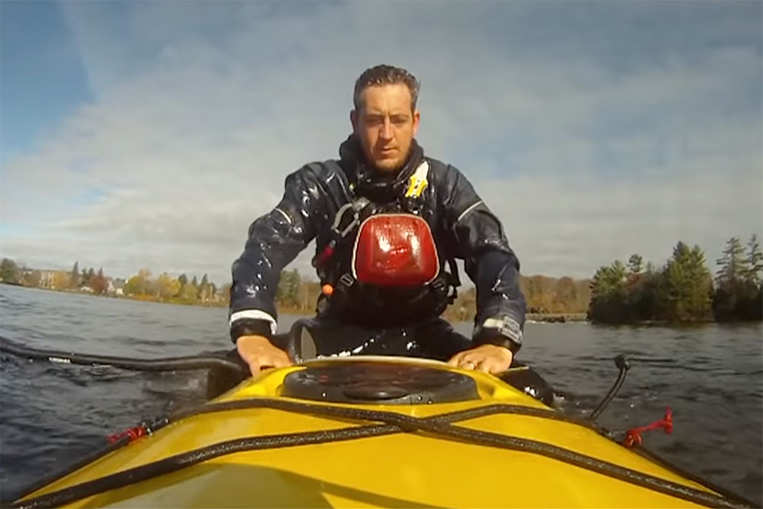 man demonstrates the sea kayaking scramble self-rescue, an important safety skill