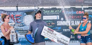 man celebrates victory on podium at a 2021 kayak fishing tournament