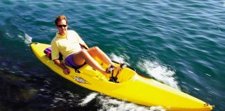 a man rides one of the first pedal drive kayaks