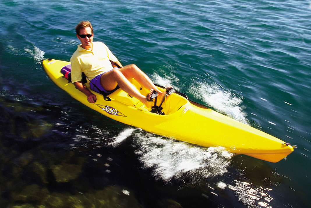 a man rides one of the first pedal drive kayaks