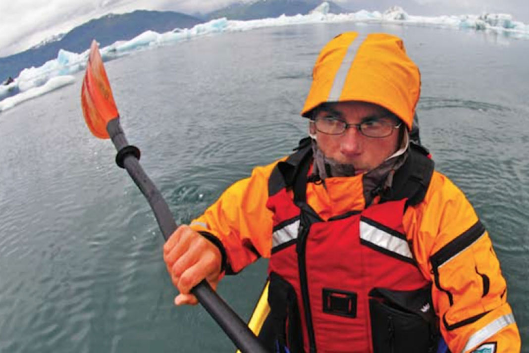 arctic paddler wears high-visibility apparel while sea kayaking, an important safety skill