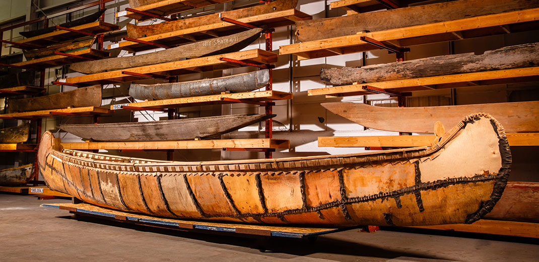 Kokomis Tchiman, a 26-foot long birchbark canoe built by Marcel Labelle, Métis elder and canoe-builder from the Mattawa Ontario region, sits on display in the Canadian Canoe Museum’s collection storage centre. Photo by Fusionriver Photography. | Courtesy of the Canadian Canoe Museum.