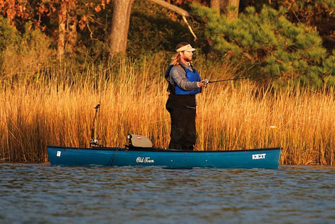 angler standing up in the Old Town NEXT hybrid kayak and canoe