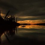 8 Simple Rules For Solo Canoe Tripping a solo person paddles while canoe tripping through the dusk light
