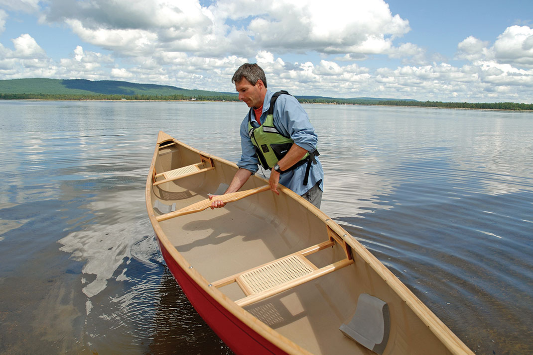 man demonstrates solo canoe lift technique