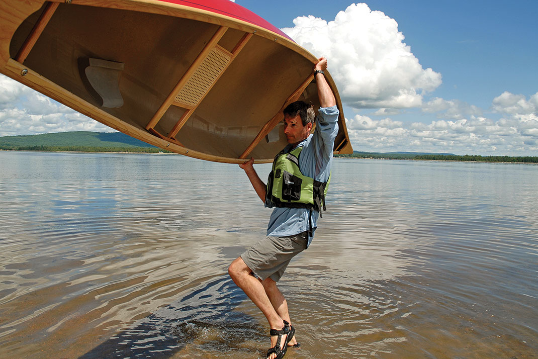 man demonstrates solo canoe lift technique
