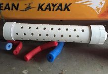 a white DIY live bait tube lies on the garage floor