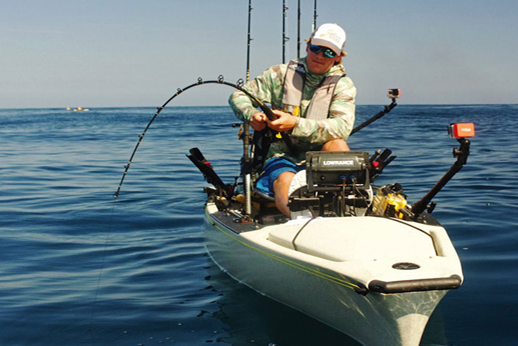 kayak angler uses a heavy duty fishing rod, best for catching big fish