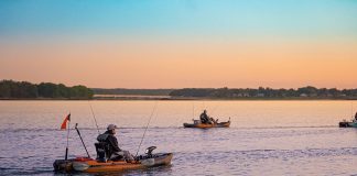 a kayak fishing guide heads out in the morning with his clients