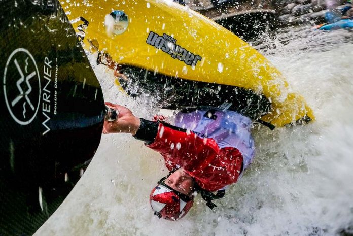 freestyle kayaker avoids mistakes while completing a move in whitewater