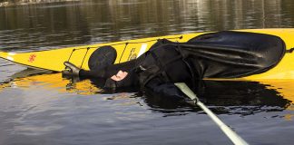 man performs the kayak balance brace maneuver