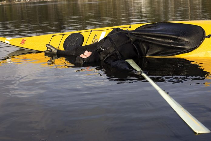 man performs the kayak balance brace maneuver