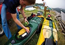 man packs for lightweight kayak camping trip