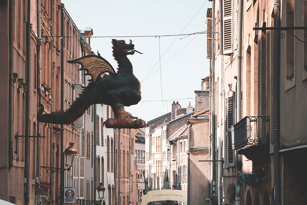 a dragon decoration hung over a street in France, originator of the word worm
