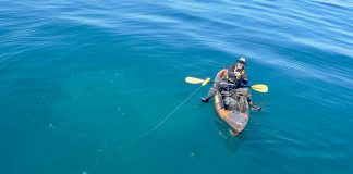 kayak angler reels in a porbeagle shark while offshore kayak fishing